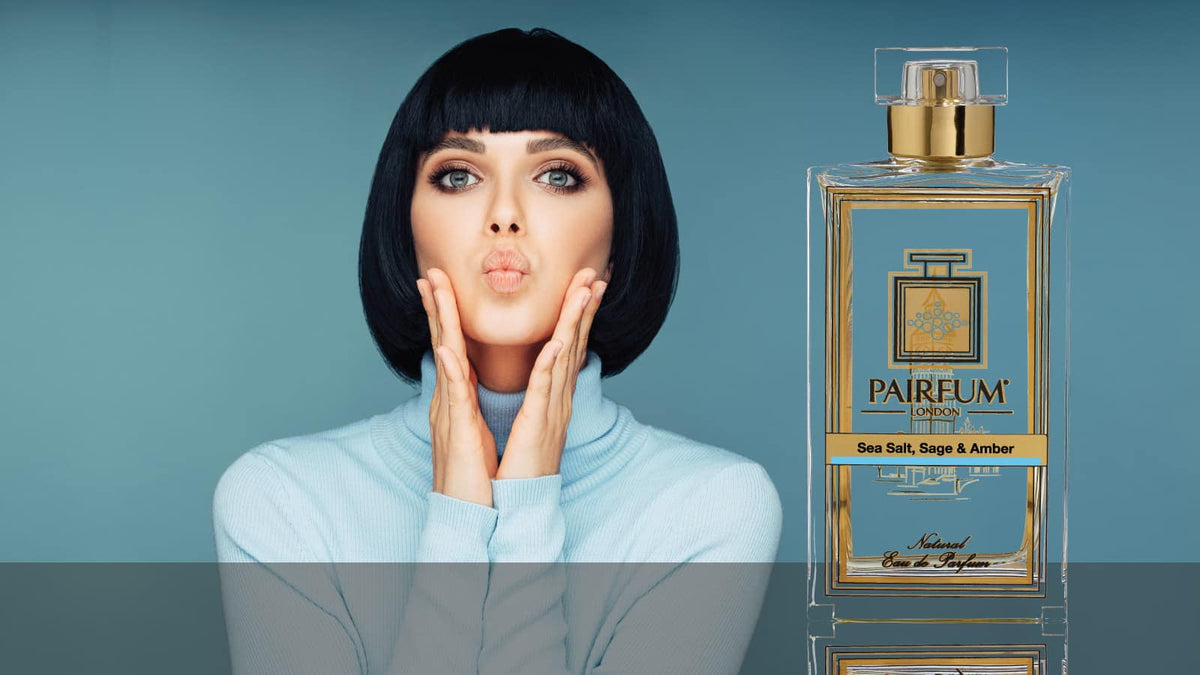 Sea Salt, Sage & Amber perfume with a woman blowing a kiss